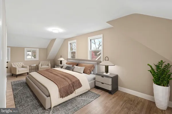 a bedroom with a bed and a potted plant