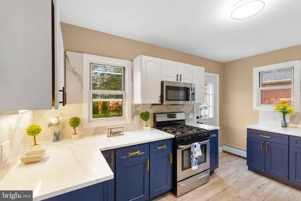 a kitchen with stainless steel appliances a stove a sink and a microwave