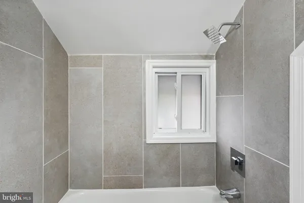 a bathroom with a window and a shower