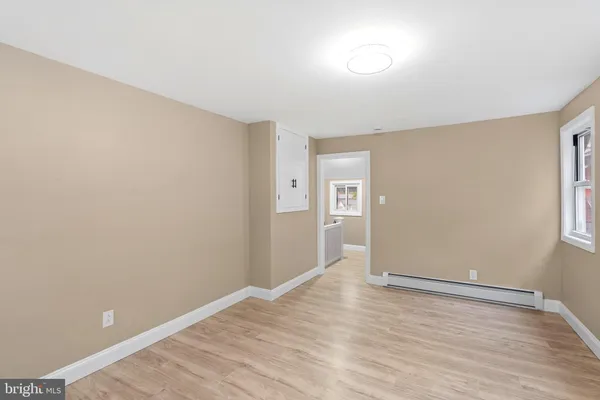 wooden floor in an empty room with a window