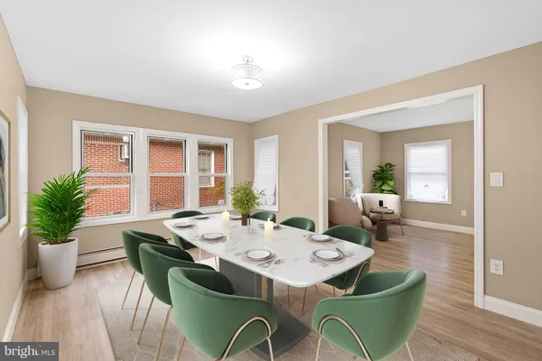 a view of a dining room with furniture window and wooden floor