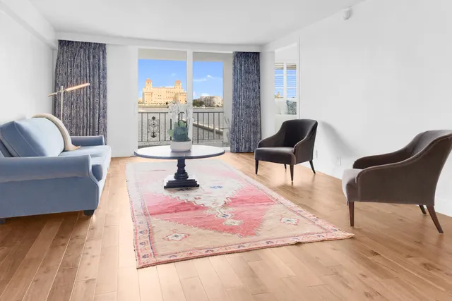 a living room with furniture and a floor to ceiling window