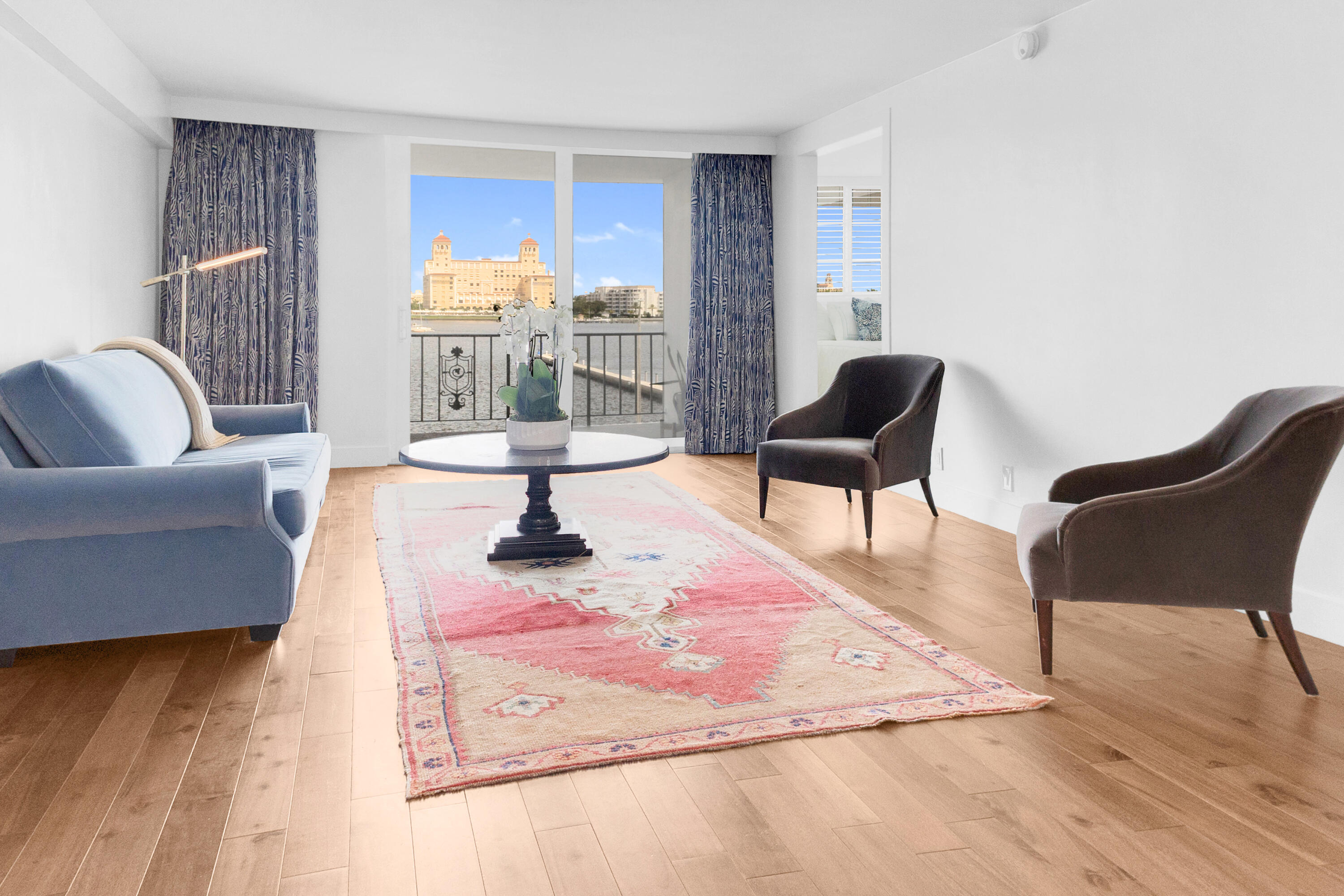 a living room with furniture and a floor to ceiling window