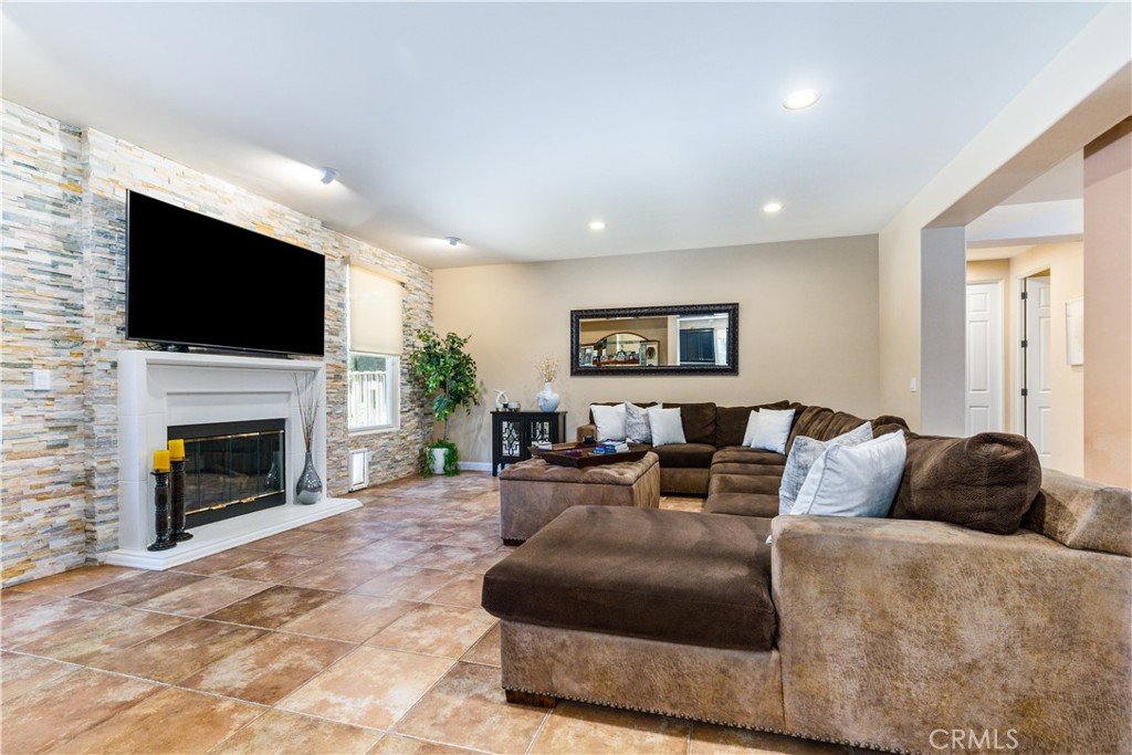 2191 Lake Ysabel Road Templeton, CA 93465 - Photo 33 of 73 a living room with furniture a fireplace and a flat screen tv
