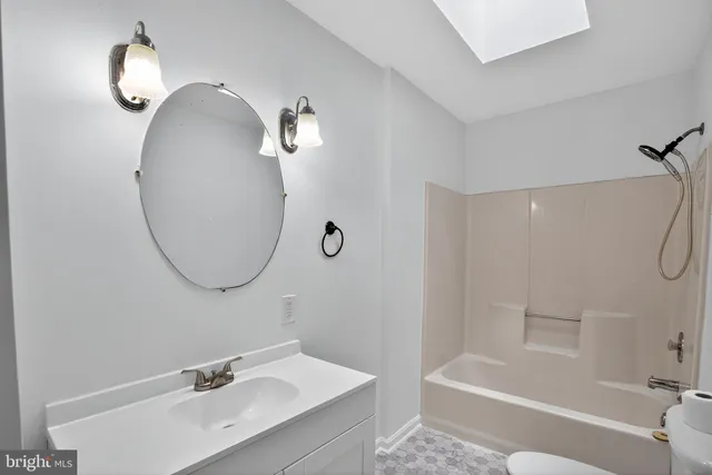 a bathroom with a sink a mirror and a shower