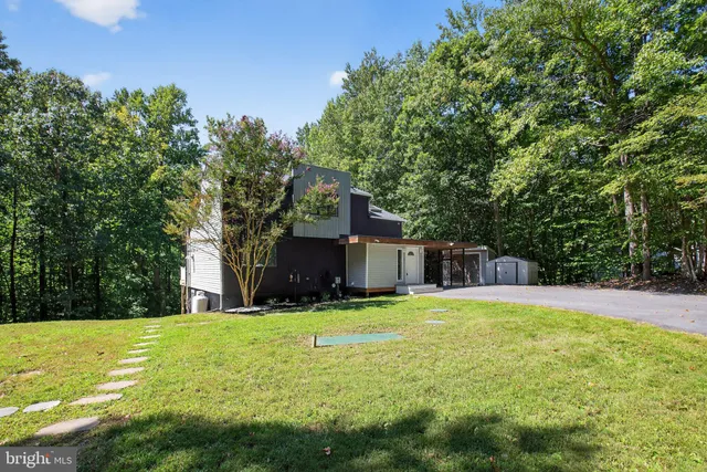 a view of swimming pool is in the backyard of house