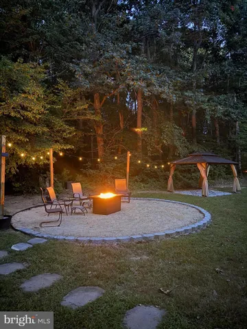 a backyard of a house with table and chairs