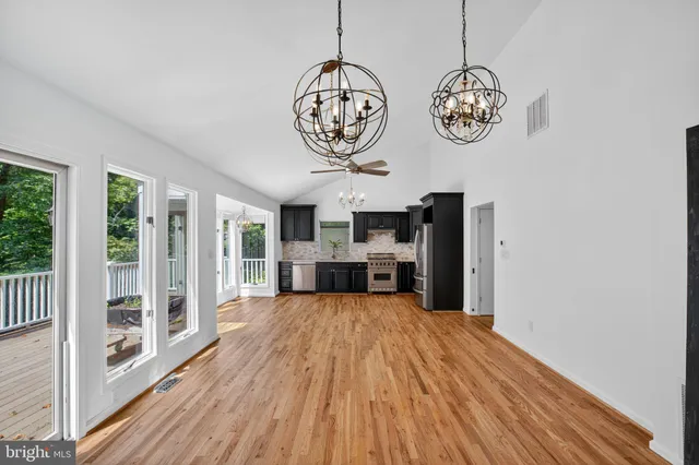a view of a room with furniture wooden floor and windows