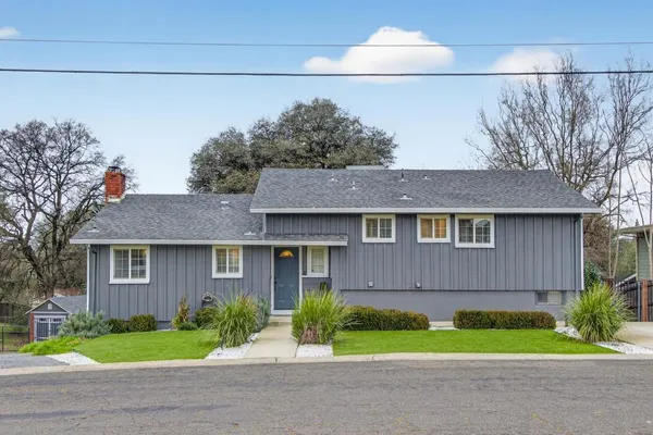 a front view of a house with garden