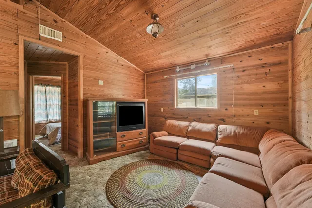 a living room with furniture windows and a flat screen tv