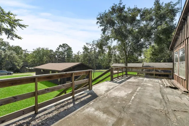a view of backyard with seating and trees