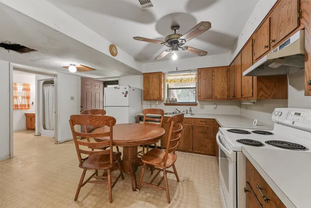 a view of a dining room with furniture and chandelier