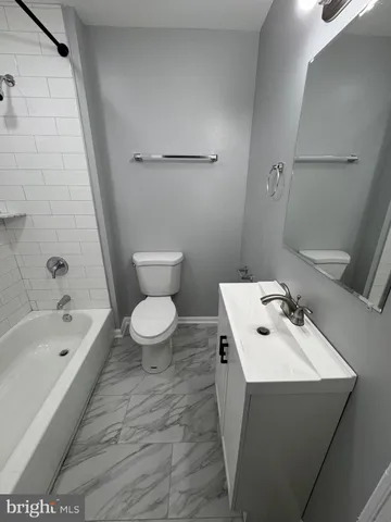 a bathroom with a sink a toilet and bathtub