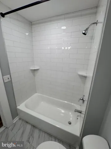 a bathroom with a bathtub and a toilet