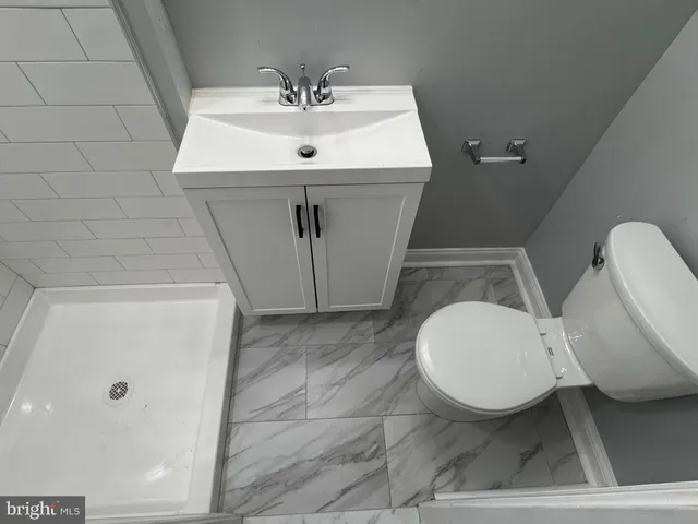 a bathroom with a sink toilet and mirror