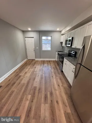 a view of kitchen with furniture and wooden floor