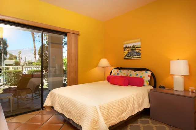 a bedroom with a bed and a night stand