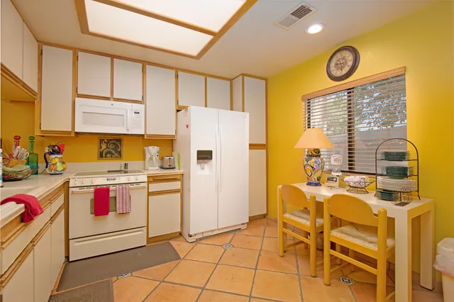 a kitchen with stainless steel appliances granite countertop a stove and a refrigerator
