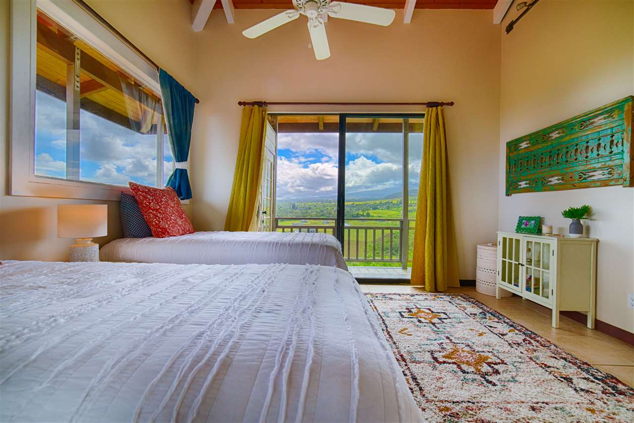 2311 Umi Place Haiku, HI 96708 - Photo 18 of 21 a bedroom with a large bed and a window