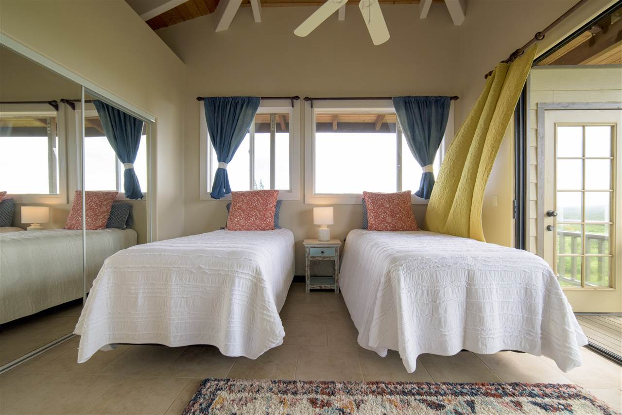 2311 Umi Place Haiku, HI 96708 - Photo 19 of 21 a bedroom with two beds and large window