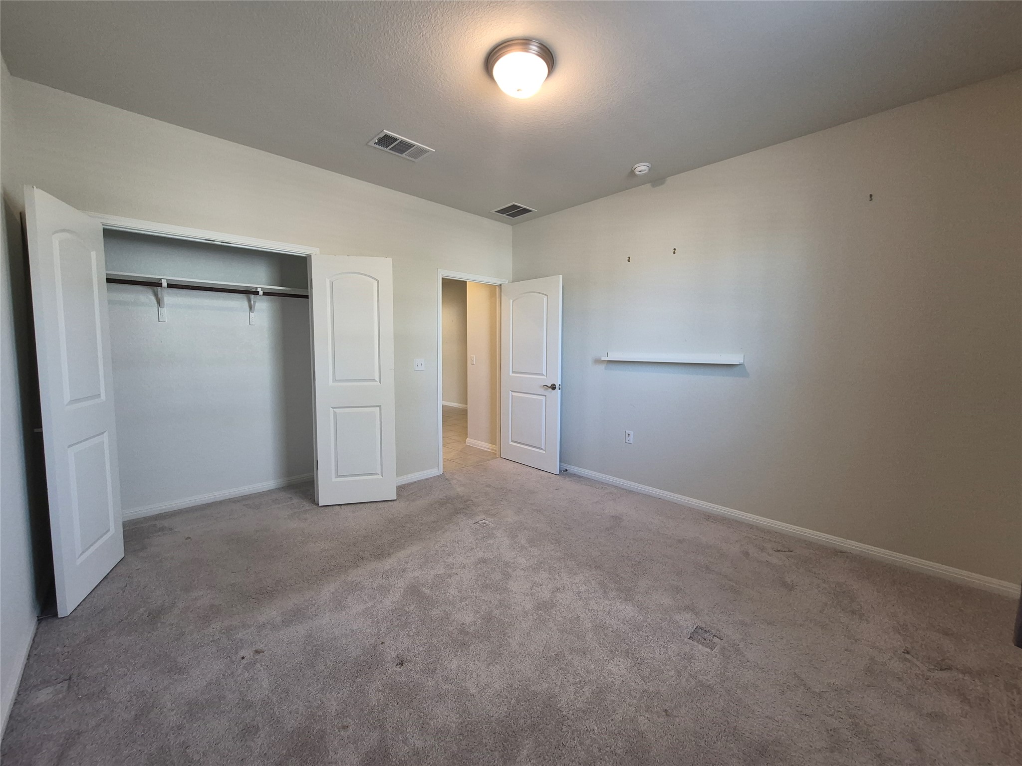 108 Calhoun Lane Georgetown, TX 78633 - Photo 10 of 27 Unfurnished bedroom with carpet floors and a closet