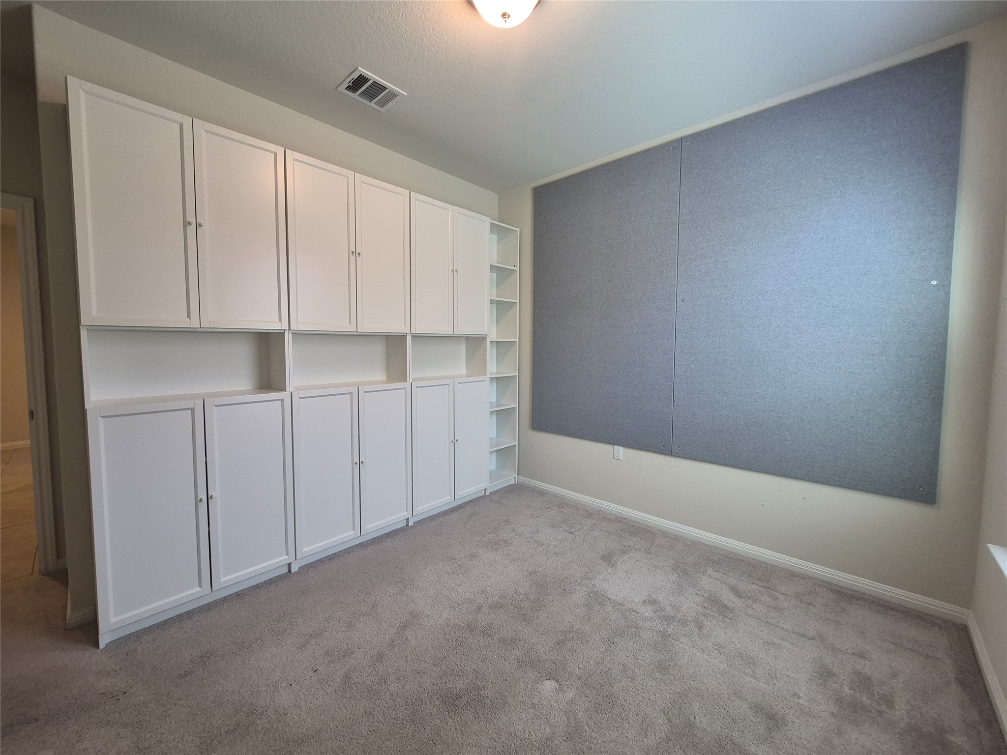 108 Calhoun Lane Georgetown, TX 78633 - Photo 15 of 27 Spare room featuring light carpet and baseboards