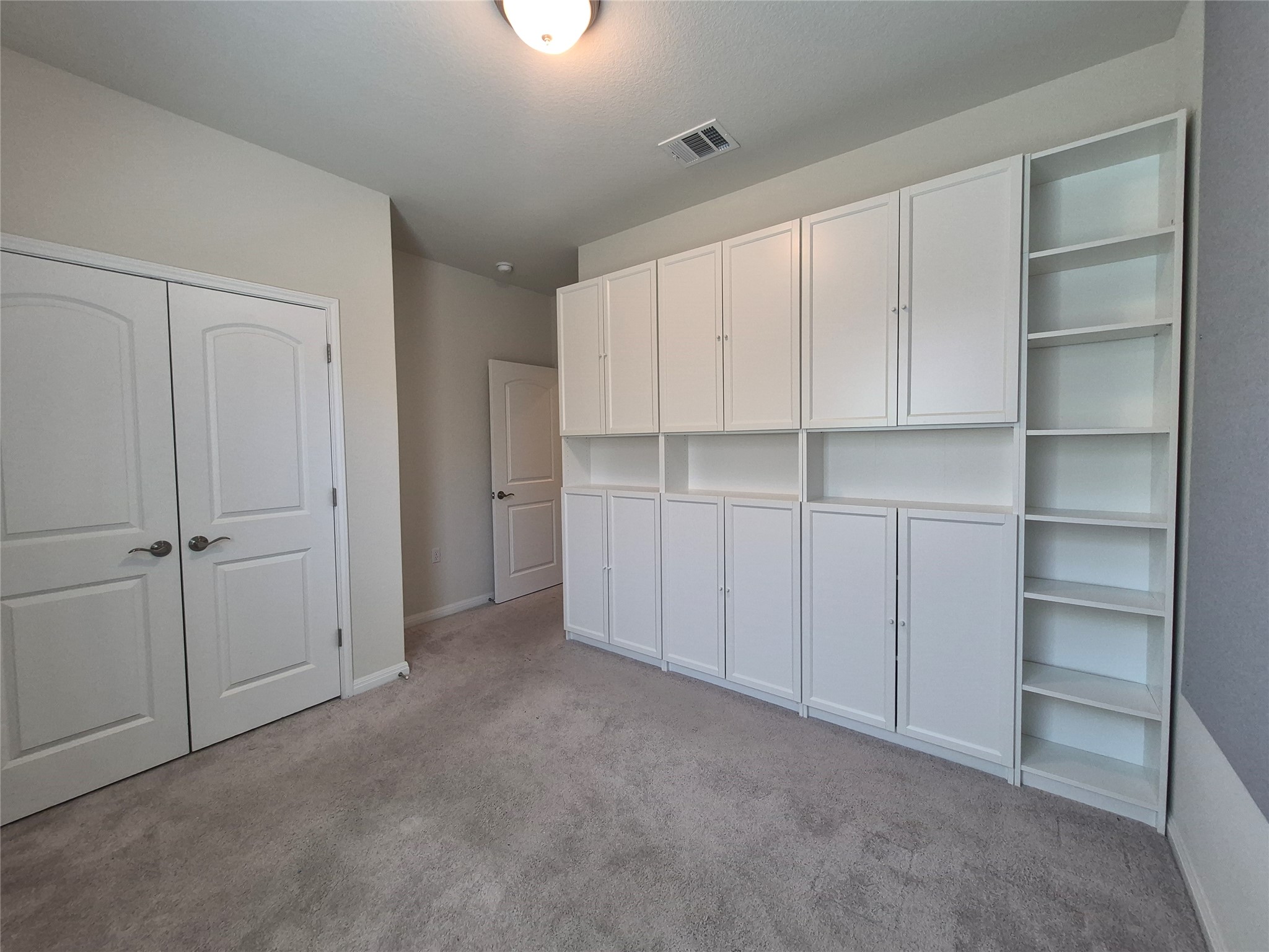 108 Calhoun Lane Georgetown, TX 78633 - Photo 16 of 27 Unfurnished bedroom with light carpet and a closet