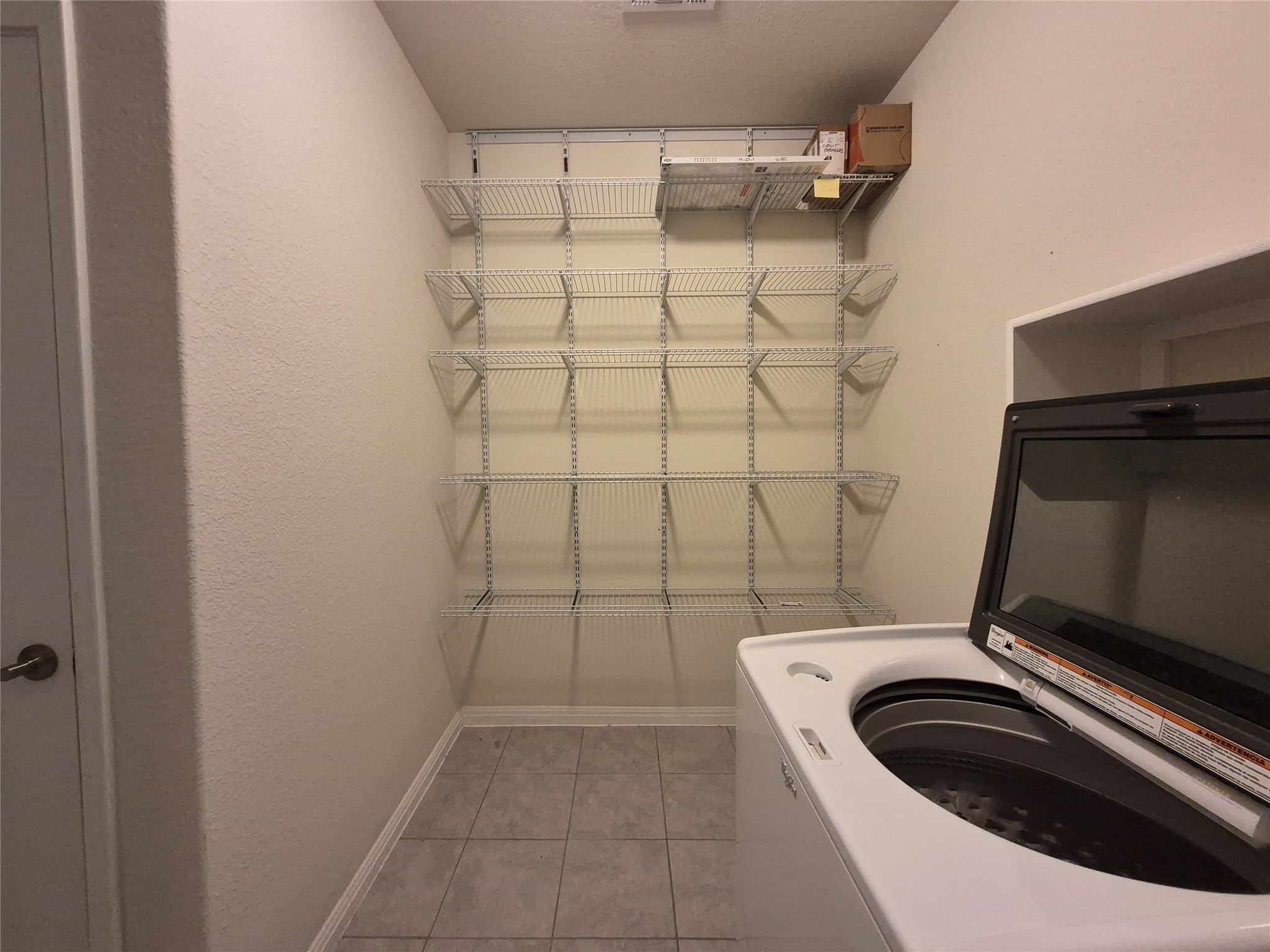 108 Calhoun Lane Georgetown, TX 78633 - Photo 18 of 27 Laundry area featuring washer / dryer and light tile patterned floors