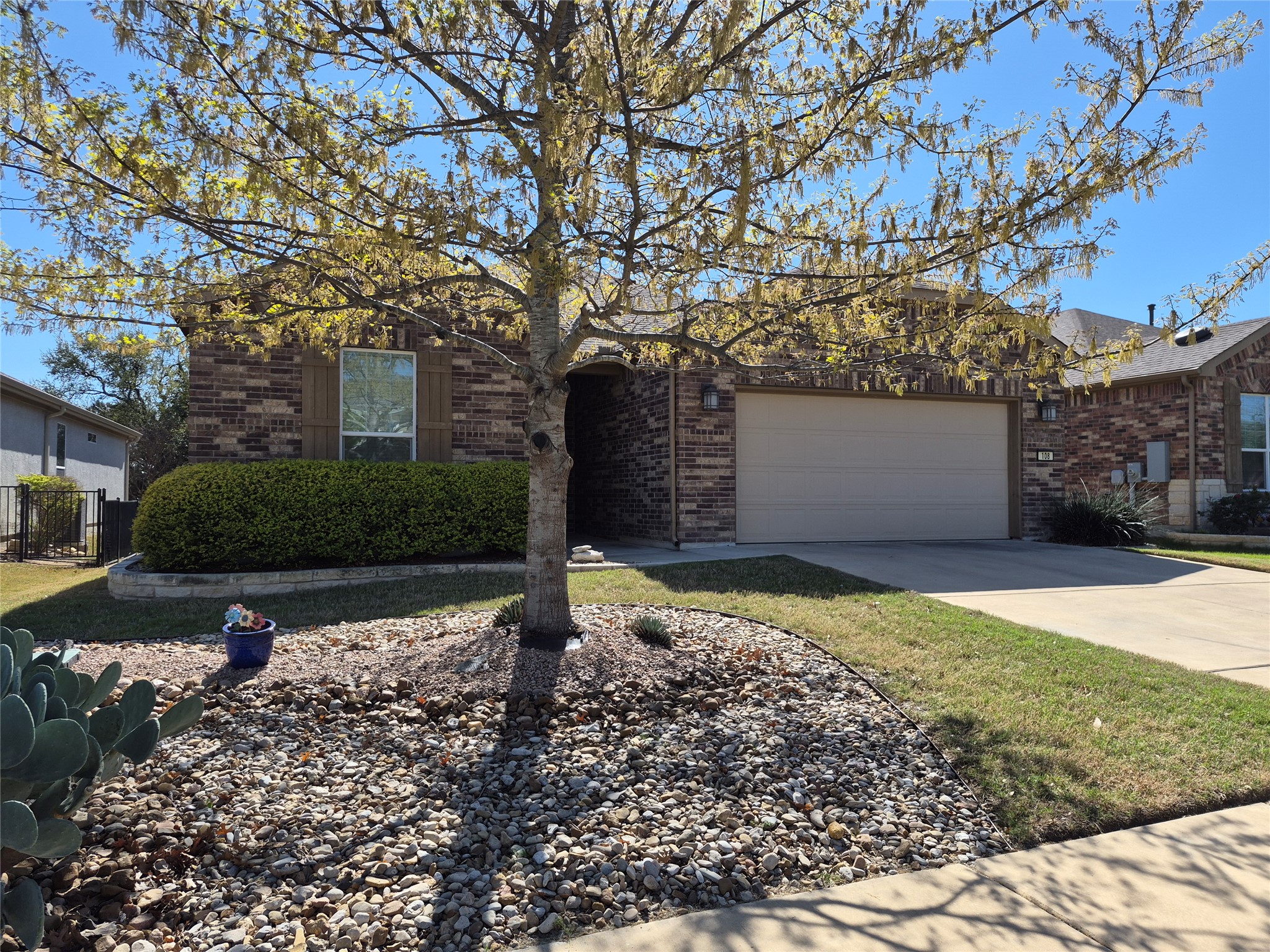 108 Calhoun Lane Georgetown, TX 78633 - Photo 2 of 27 View of front facade featuring brick siding, driveway, and an attached garage
