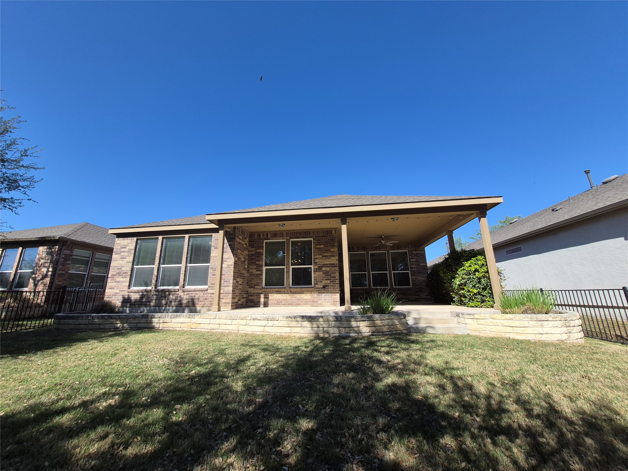 108 Calhoun Lane Georgetown, TX 78633 - Photo 19 of 27 Back of house featuring a patio area, brick siding, and ceiling fan