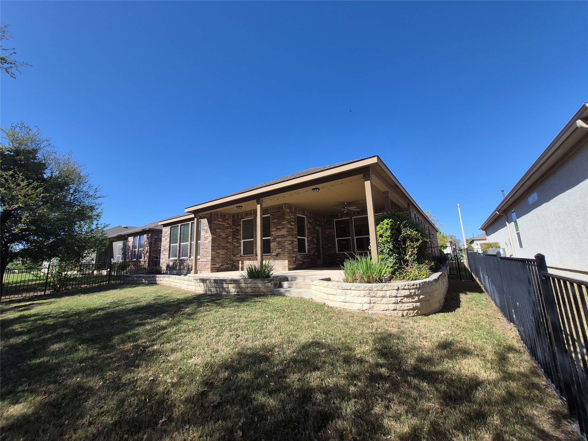 108 Calhoun Lane Georgetown, TX 78633 - Photo 23 of 27 Rear view of property featuring a fenced backyard, a patio area, ceiling fan, and brick siding