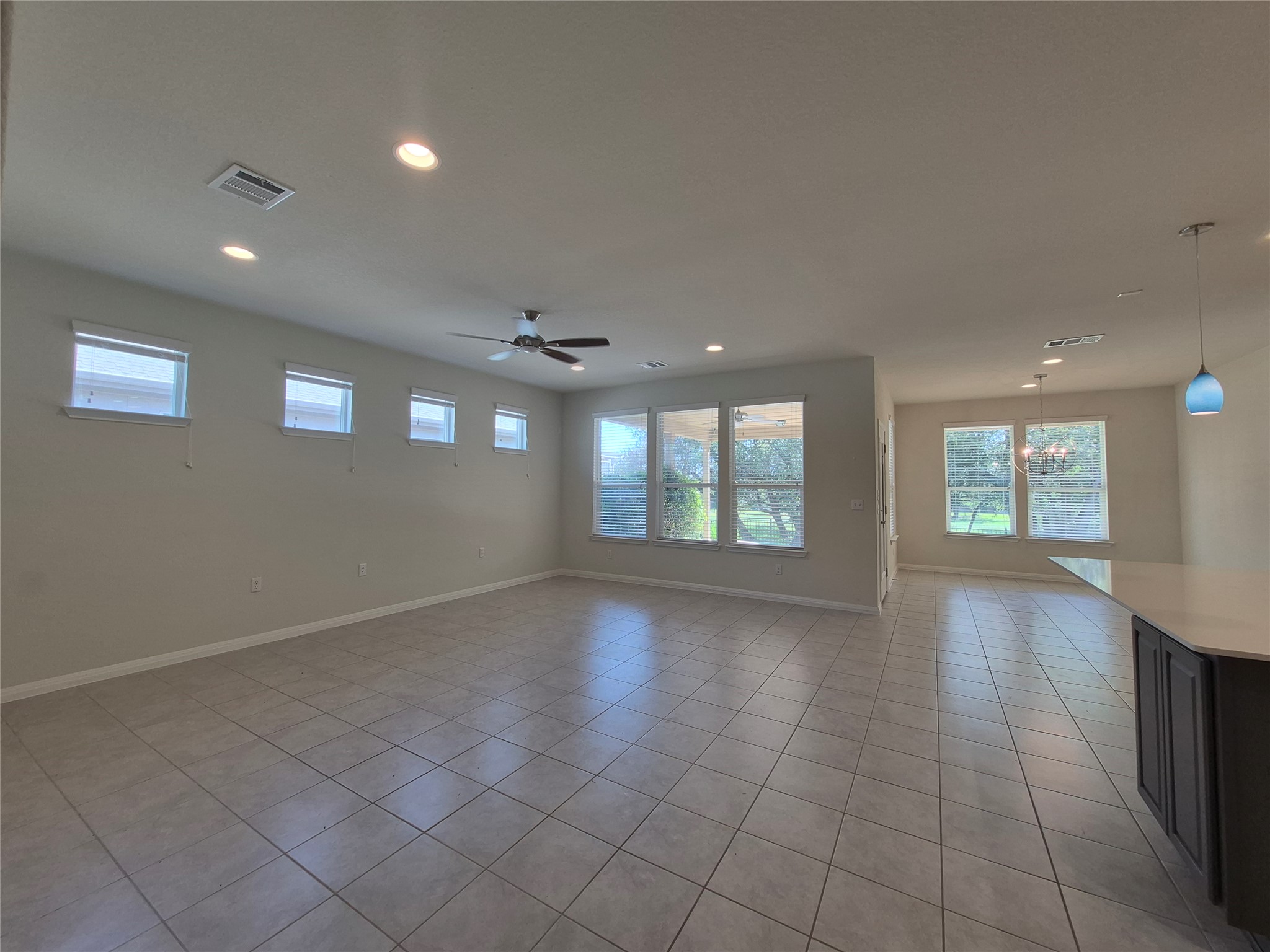 108 Calhoun Lane Georgetown, TX 78633 - Photo 6 of 27 Unfurnished room with plenty of natural light, light tile patterned floors, ceiling fan, and recessed lighting