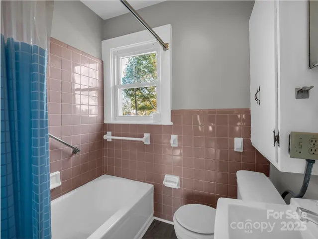 a bathroom with a toilet and shower