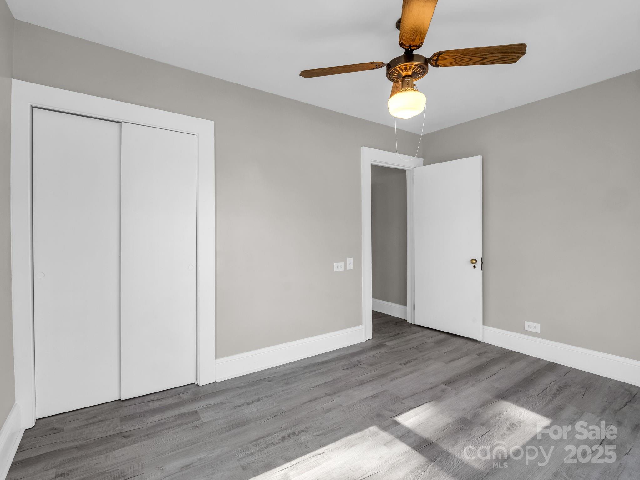 4501 Polkville Road Shelby, NC 28150 - Photo 18 of 35 a view of an empty room with window a ceiling fan and wooden floor