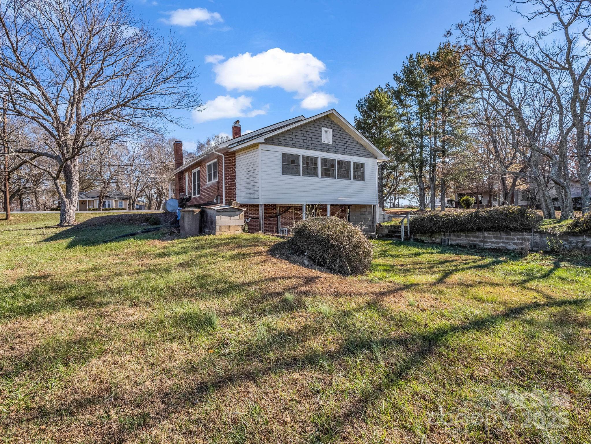 4501 Polkville Road Shelby, NC 28150 - Photo 27 of 35 a front view of a house with a yard covered with snow and trees
