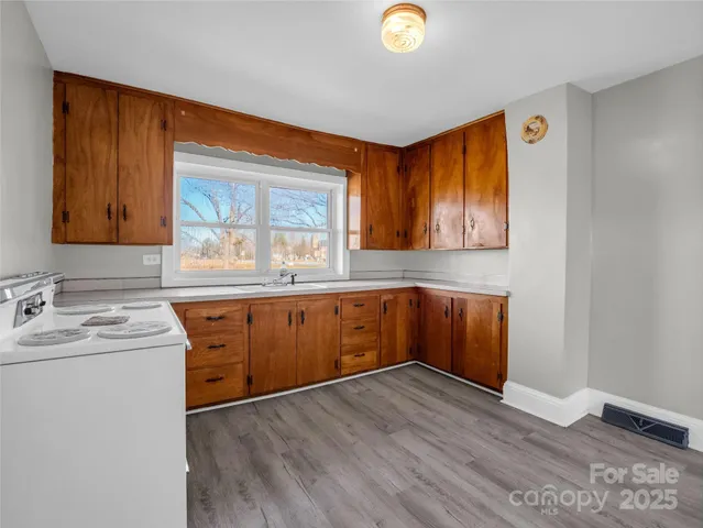 a kitchen with sink and cabinets
