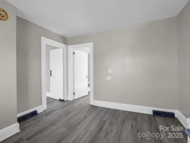 a view of an empty room and wooden floor