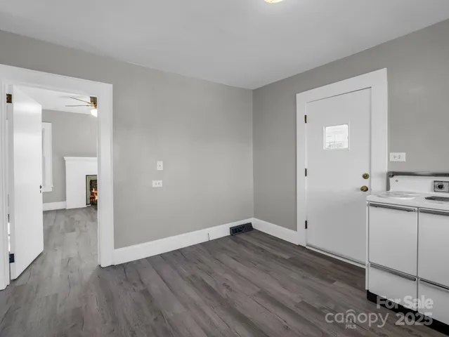 a view of a room with wooden floor