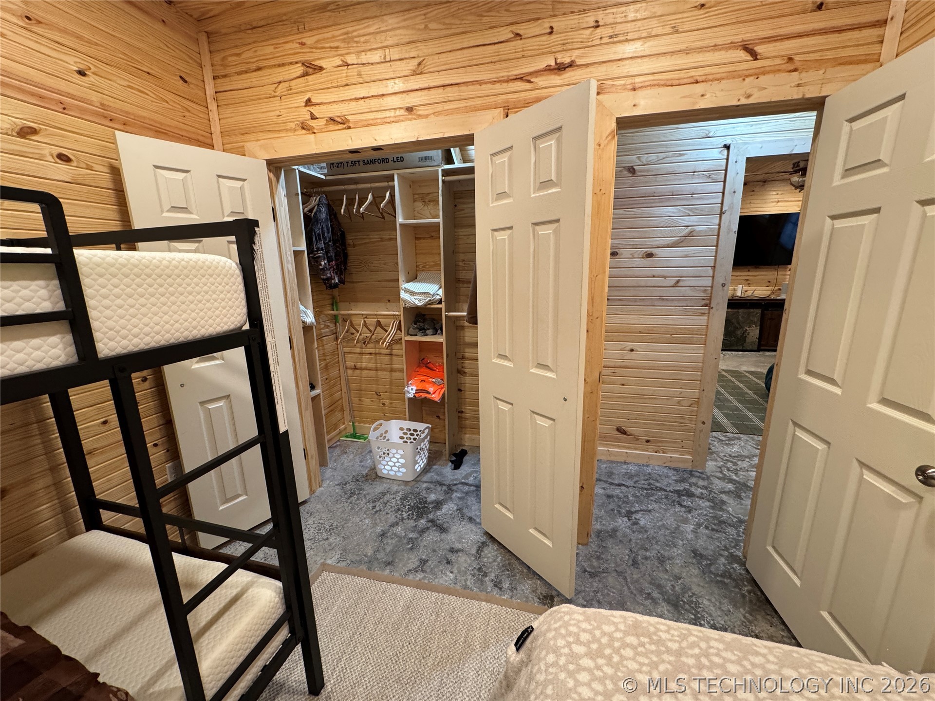 20862 East 1160th Road Keota, OK 74941 - Photo 28 of 47 Wood-paneled room featuring a built-in closet with shelving and hanging space