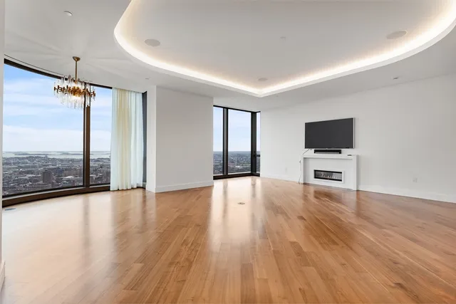 a view of a livingroom with wooden floor and flat screen tv