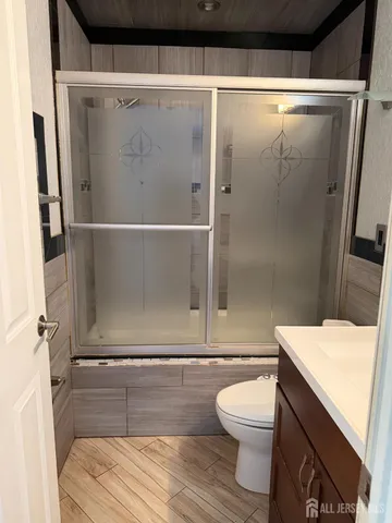a bathroom with a sink toilet and shower