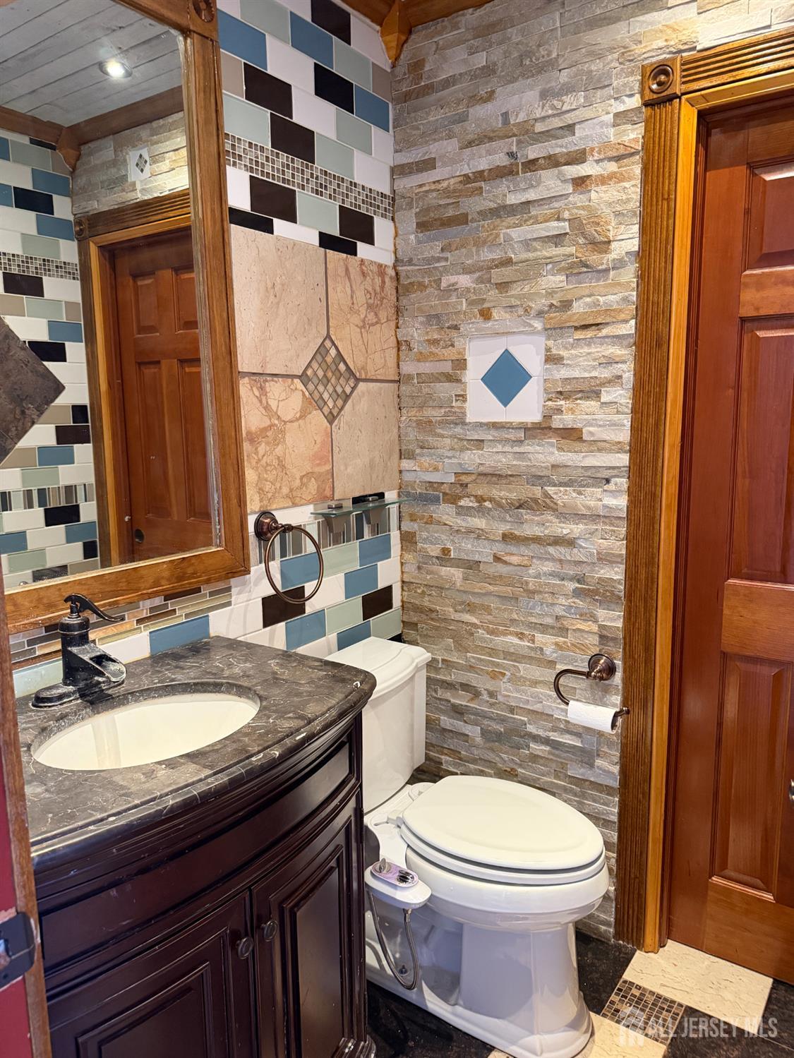 176 Nebula Road Piscataway, NJ 08854 - Photo 5 of 22 a bathroom with a granite countertop toilet sink and mirror