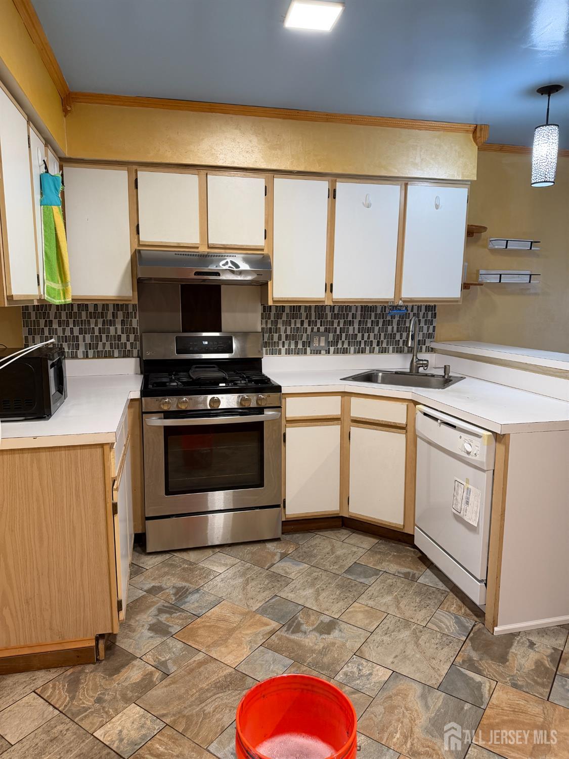 176 Nebula Road Piscataway, NJ 08854 - Photo 6 of 22 a kitchen with a stove top oven sink and cabinets