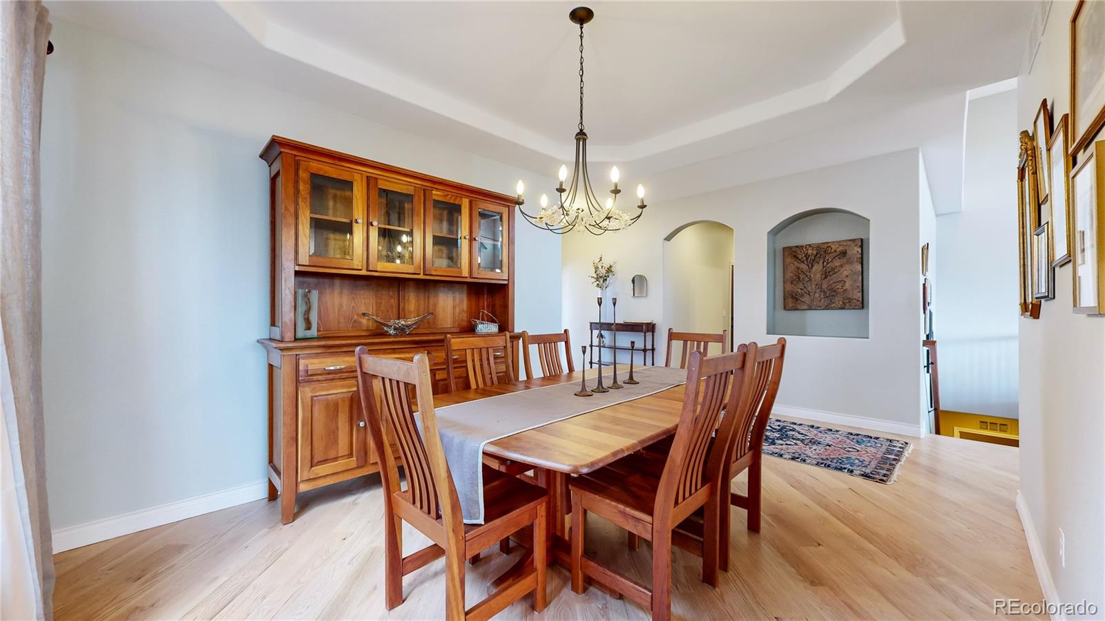 8400 Quaker Circle Arvada, CO 80007 - Photo 13 of 50 a view of a dining room with furniture and a chandelier