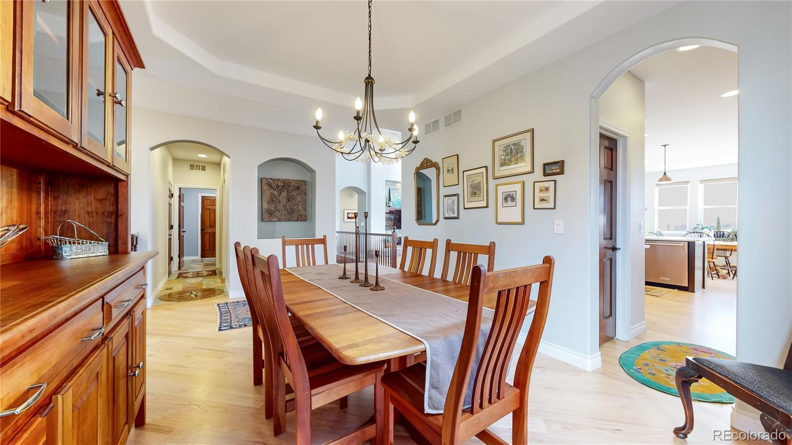 8400 Quaker Circle Arvada, CO 80007 - Photo 14 of 50 a view of a dining room with furniture and a chandelier