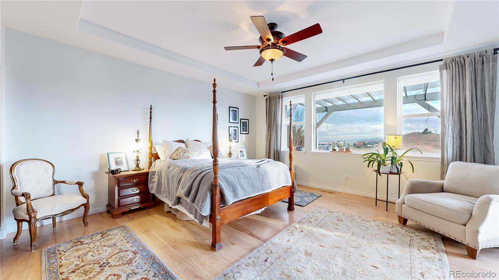 8400 Quaker Circle Arvada, CO 80007 - Photo 16 of 50 a bedroom with a bed and a chandelier