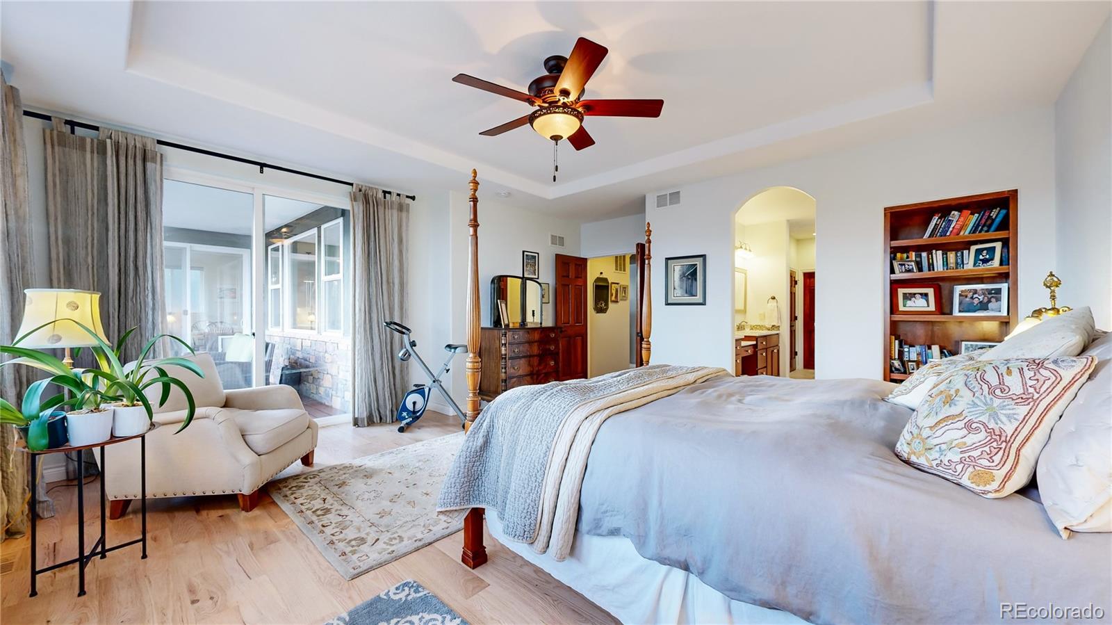 8400 Quaker Circle Arvada, CO 80007 - Photo 18 of 50 a bedroom with a bed couches and a dining table with wooden floor