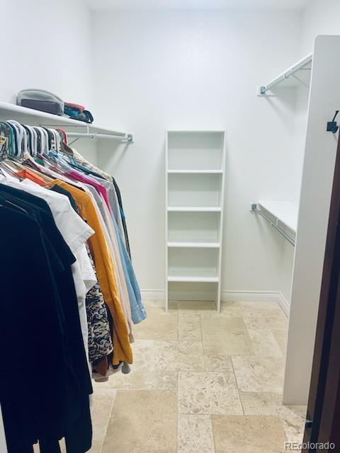 8400 Quaker Circle Arvada, CO 80007 - Photo 22 of 50 a view of walk in closet with clothes and shoes