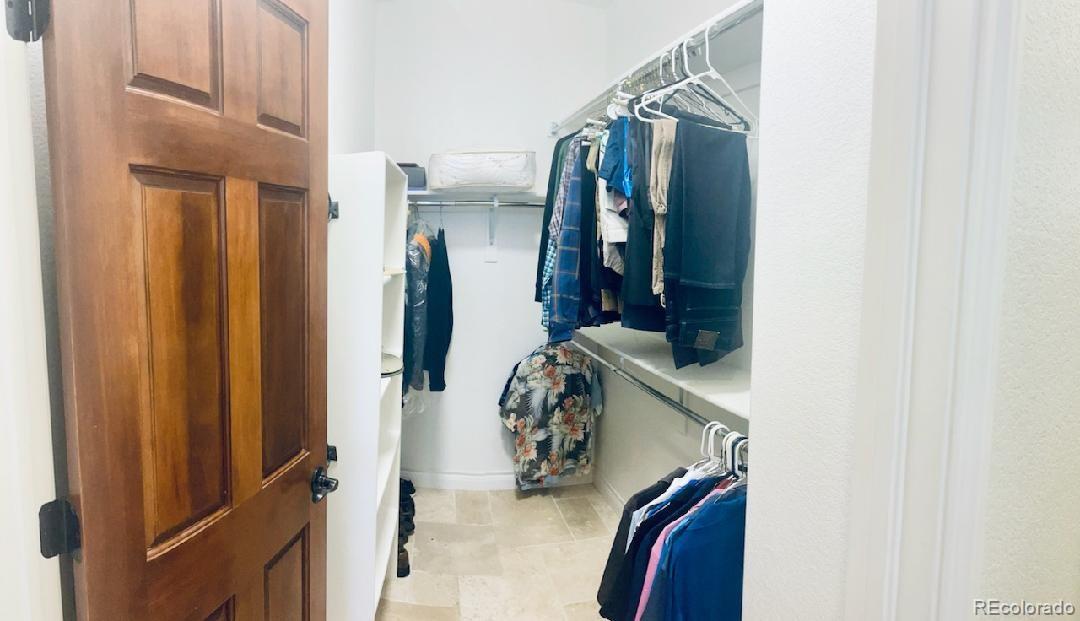 8400 Quaker Circle Arvada, CO 80007 - Photo 29 of 50 a view of walk in closet with clothes and shoes
