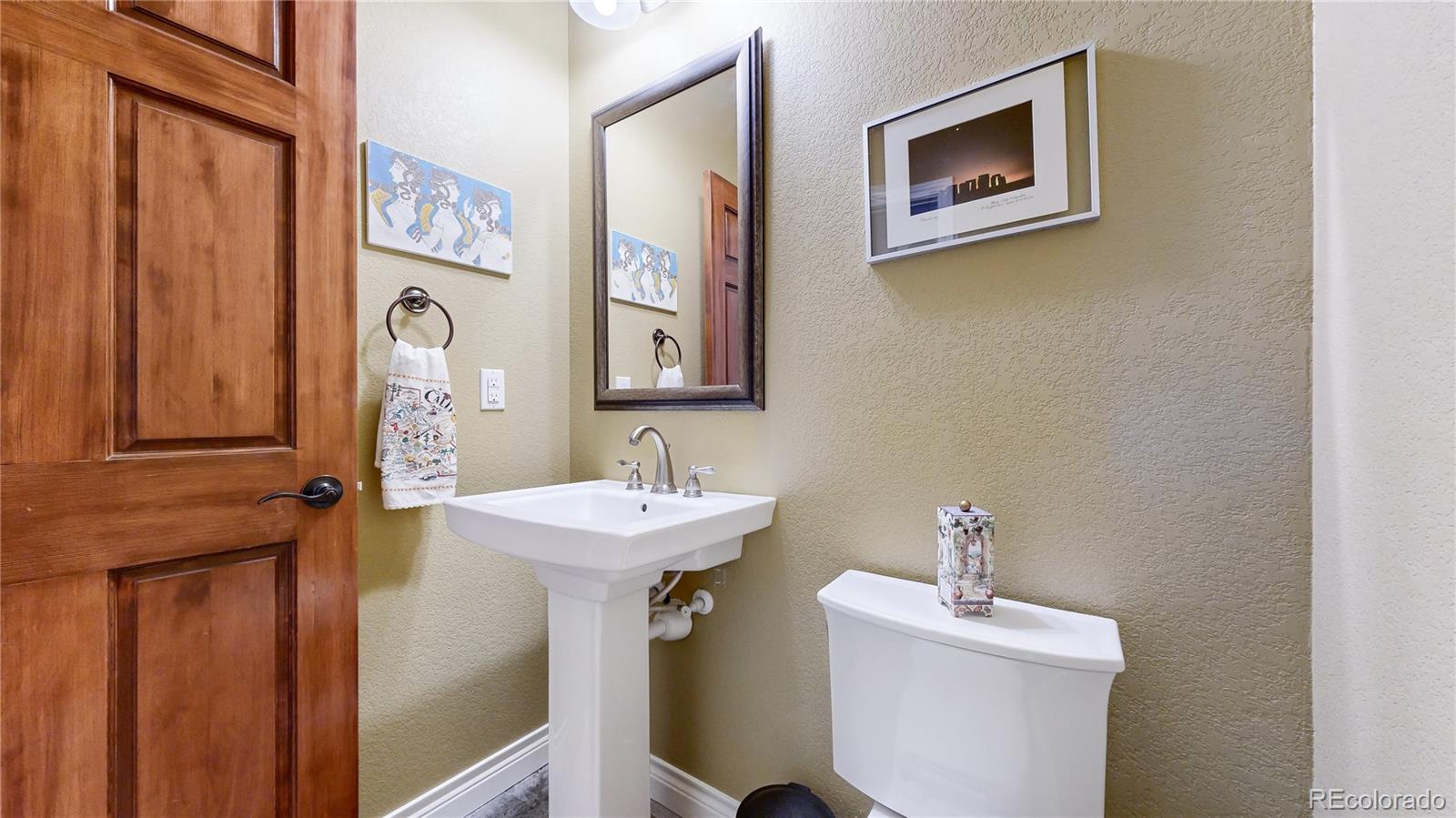 8400 Quaker Circle Arvada, CO 80007 - Photo 30 of 50 a bathroom with a sink and mirror with toilet